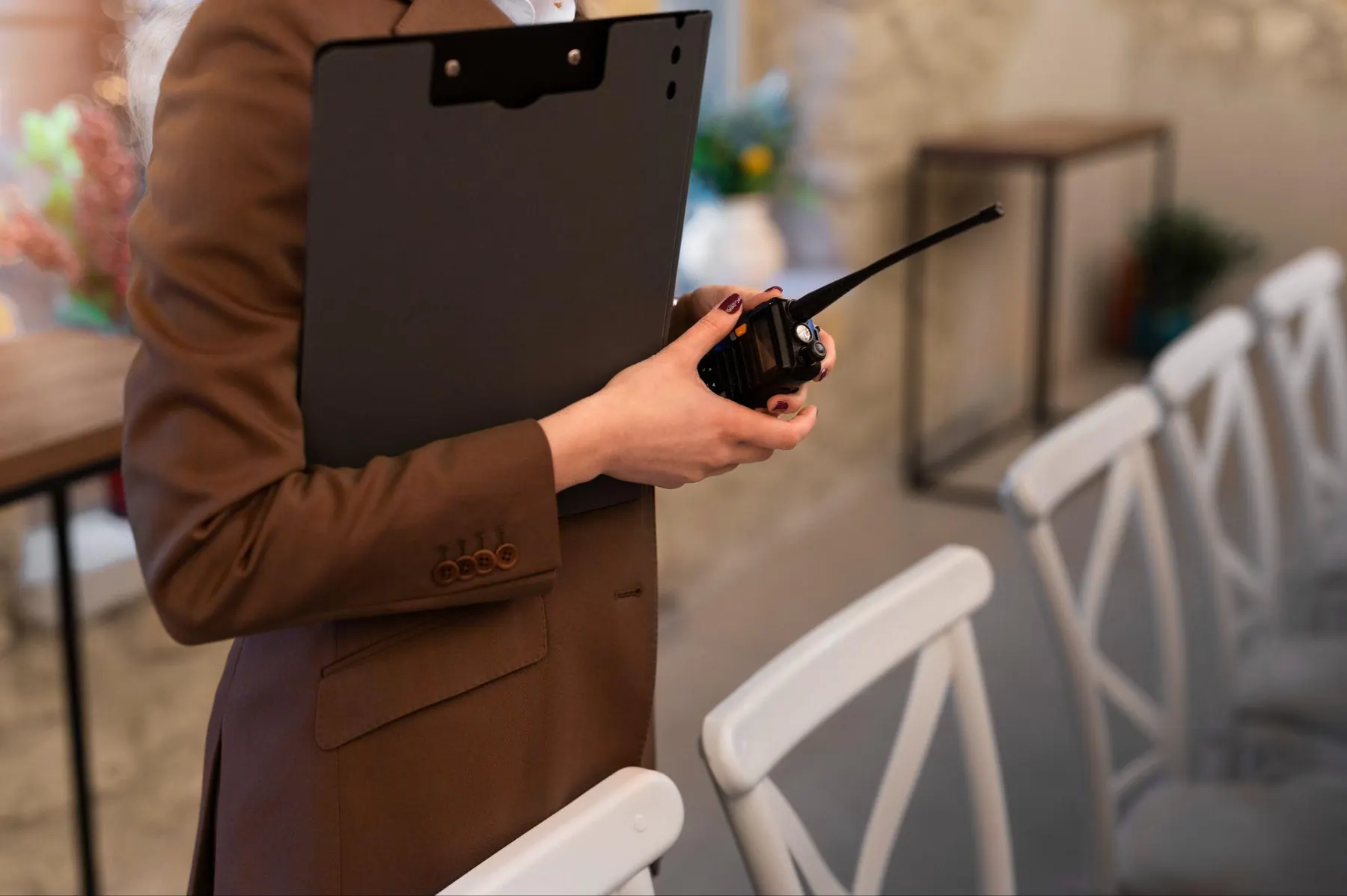 Event coordinator holding a clipboard and radio